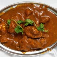 Lamb Curry · Goat curry cooked with regular spices creates enough gravy to have with rice or Indian bread.