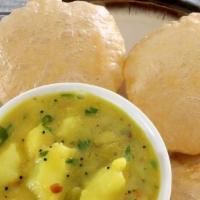 Poori Bhaji [3] · Puffy wheat bread deep fried served with bhaji (potato curry).