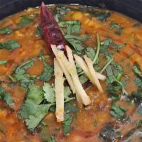 Yellow Daal · Yellow lentils cooked with onions, tomatoes, and spices.