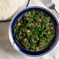 Tabbouleh Salad · Thinly diced parsley tomatoes onions and mint mixed with bulgur lemon juice and olive oil.
