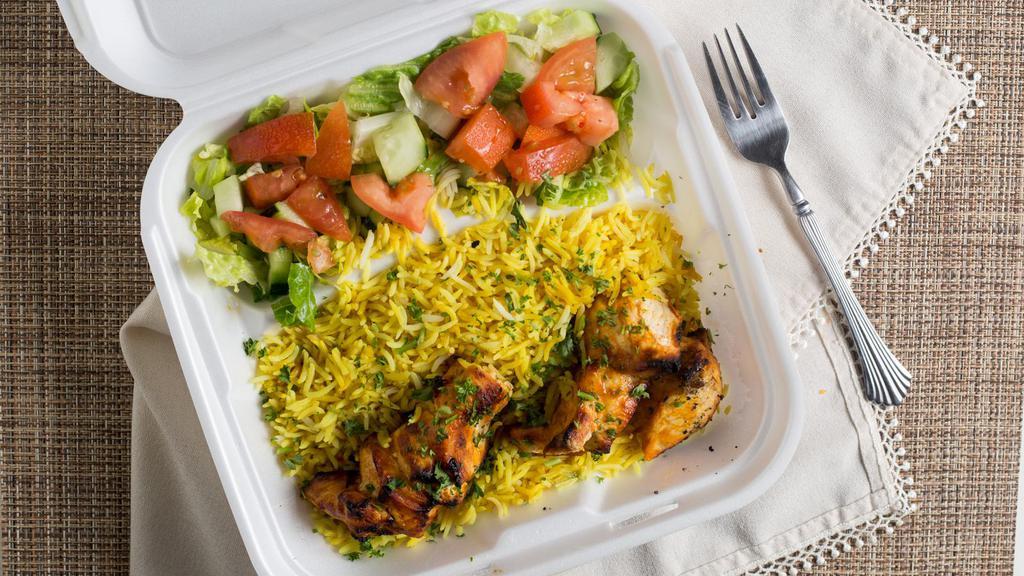 Chicken Kebab (Tawook) · Marinated chicken cubes in yogurt lemon juice and special spices char-broiled and served over rice, salad, pickles and homemade garlic sauce.