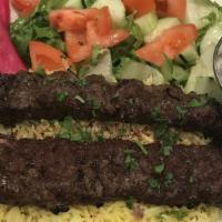 Beef Kebab · Tender beef cubes char-broiled to perfection. Served over rice, salad and pickles.