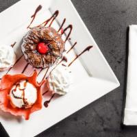 Molten Chocolate Cake · Our moist chocolate cake enrobed with dark chocolate... filled with a dark chocolate truffle...