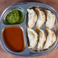 Vegetable Momo · Dairy-free, Nut-free, CONTAINS GLUTEN. 12 handmade dumplings steamed - served with special c...