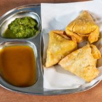 Samosa · Dairy-free, CONTAINS GLUTEN. Crispy pastry with potatoes and peas deep-fried.