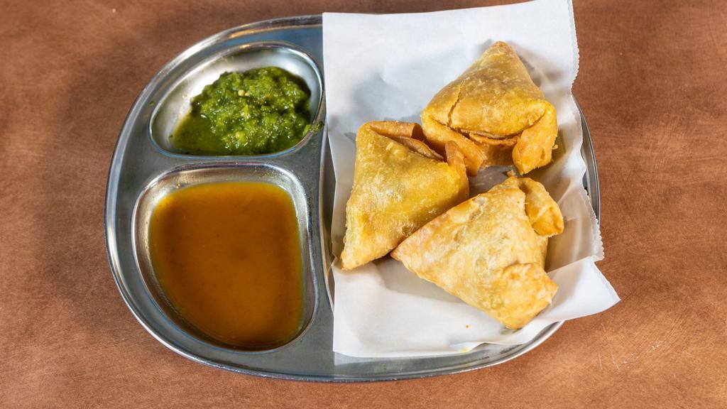 Samosa · Dairy-free, CONTAINS GLUTEN. Crispy pastry with potatoes and peas deep-fried.