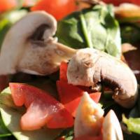 Spinach Salad · Fresh baby spinach, bacon, tomatoes, mushrooms, caramelized pecans & goat cheese served with...