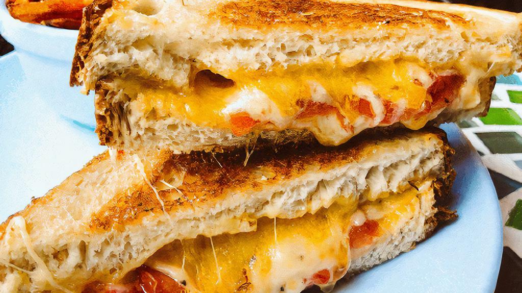 Ultimate Grilled Cheese · Gruyere, cheddar & parmesan cheese grilled to perfection with roasted tomatoes