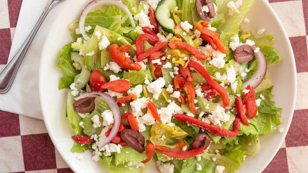 Greek Salad · Chopped romaine, cucumbers kalamata olives, red onion, roasted red pepper, grape tomatoes, pepperoncinis, crumbled feta cheese with Greek vinaigrette.
