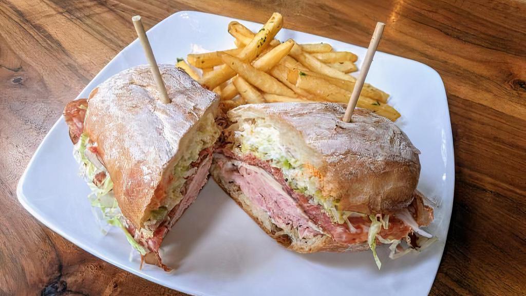 Grinder · Copa, calabrese, black forest ham, aged provolone, pepper relish, red onion, shredded iceberg, lemon-garlic aioli.  With fries.