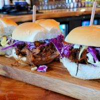 Pulled Pork Sliders · Slow cooked pork pulled and lightly cooked in our Smokey Sweet BBQ sauce topped with coleslaw