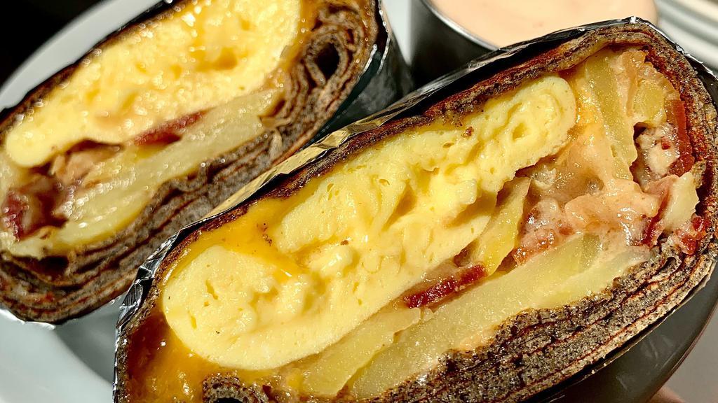 Big Breakfast · Potatoes au gratin, two eggs scrambled, hardwood smoked bacon, onion jam, cheddar, and Louisiana crème fraîche