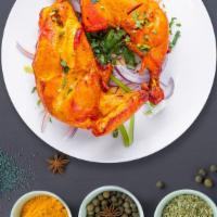 The Classic Chicken Tandoori · Juicy chicken dipped in a yogurt & ground spice marinate and baked in a tandoor clay oven