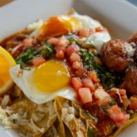 Spicy Chilaquiles · Two eggs any style, tomatoes, onions, cilantro, queso fresco, breakfast potatoes.