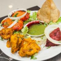 Taste Of India Delight · A selection of vegetable samosa, vegetable pakora, chicken tikka, and chicken pakoras. Serve...