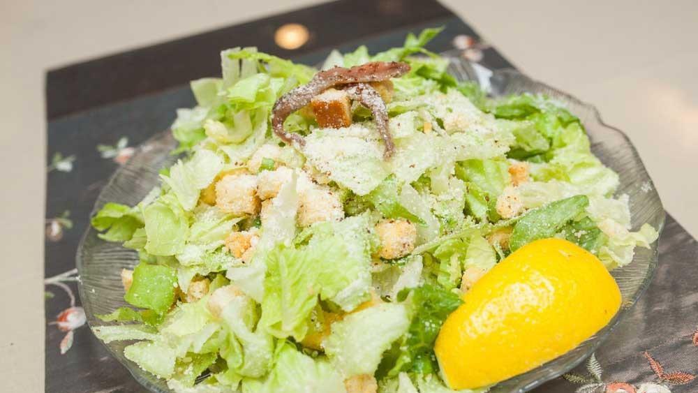 Caesar Salad · Fresh romaine lettuce prepared with a classic Caesar dressing and croutons.