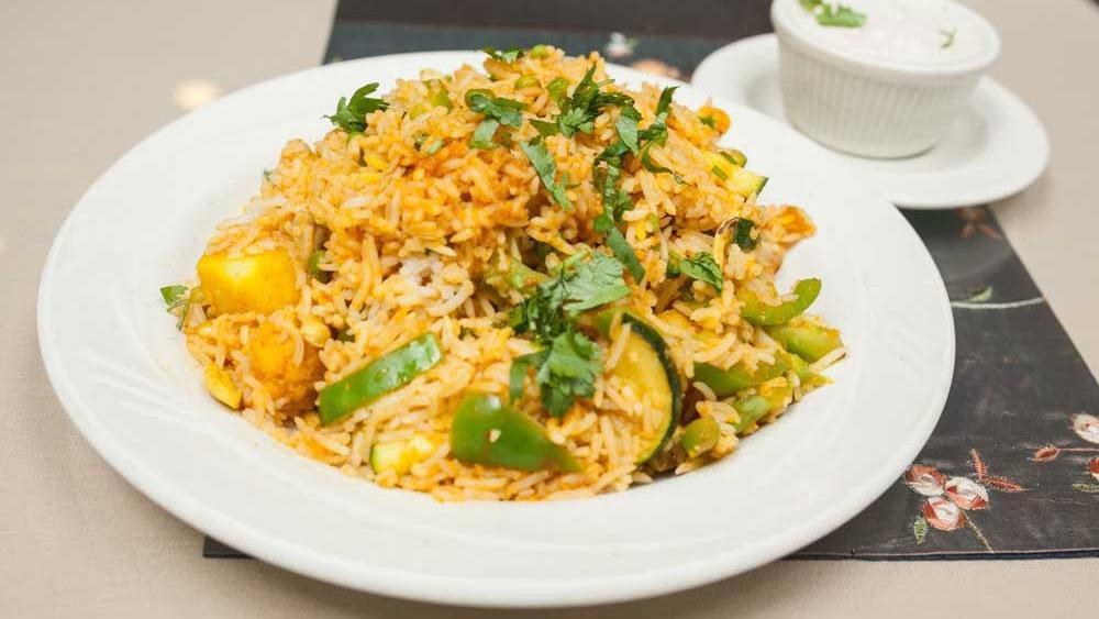 Royal Biryani Lunch · Gluten-free, vegan. Not a Hyderabadi style. A classic mughlai dish of basmati rice cooked with curry, raisins, cashew nuts, sauteed onions and saffron. Served with raita. All spices are American standard.