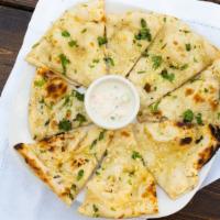 Garlic Naan · Clay oven baked flour bread, stuffed with fresh garlic and cilantro.
