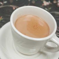 Iced Chai · An ancient tea of India, made up of black tea, milk, cardamom, cloves, fennel and sugar.