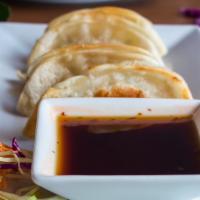 Gyoza  · Wonton wrappers stuffed with your choice of chicken or pork.