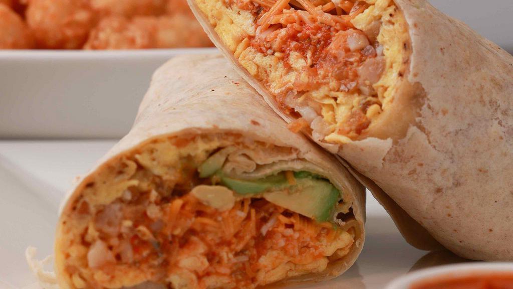 Lucky Charmer · Eggs, tater tots, ham, avocado, hot peppers, salsa and mixed cheese rolled in a flour tortilla wrap. Served with hot sauce.