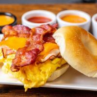 Piggy Bagel (Hot Sammy) · Eggs, bacon, ham and melted American cheese on your choice of toasted bagel.