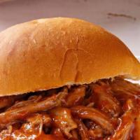 Pulled Pork · Pork marinated and slow-cooked for hours. Served with BBQ sauce on a brioche bun.