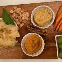 Hummus Plate · Susanne’s hummus, warm pita bread, seed crackers, 
olives, vegetables