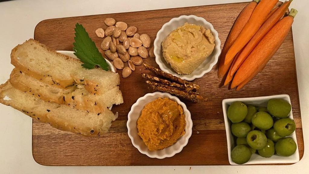 Hummus Plate · Susanne’s hummus, warm pita bread, seed crackers, 
olives, vegetables