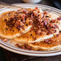 Nutty Pig Pancakes · Three buttermilk pancakes topped with creamy peanut butter and crisp bacon and maple syrup.s...