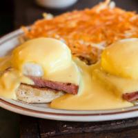Classic Eggs Benedict · Grilled ham steak on toasted English muffin topped with two eggs cooked to order and smother...