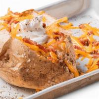 Loaded Baked Potato · Baked potato topped with shredded cheddar cheese, bacon, sour cream and whipped butter. Serv...