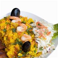 Paella Plate · Seafood rice with vegetables. Served with maduros, salad, onion, bell pepper and cilantro.
