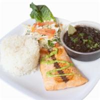 Fish Plate · Swai fillet. Served with rice, black beans, salad, onion, and green sauce.