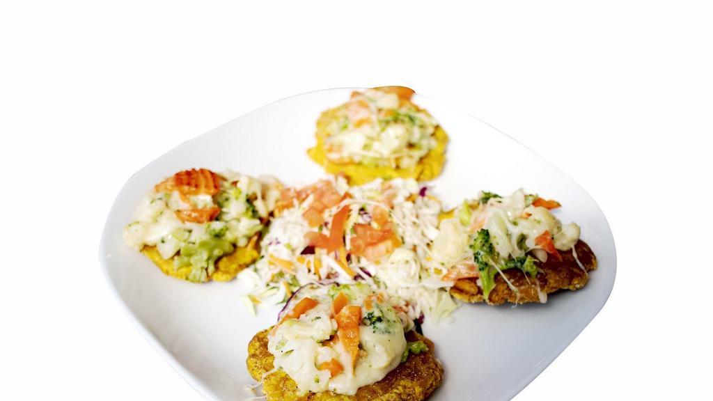Veggie Tostones · Deep fried green plantains topped with mixed vegetables, mozzarella cheese, cilantro and salad.