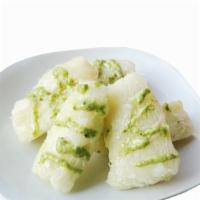 Yuca Con Mojo · Boiled yucca with sauce.