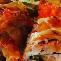 Beauty & The Beast Roll · Shrimp tempura, eel, avocado, crab salad top with seer salmon, tuna, tiger sauce.