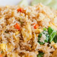 Veggie Fried Rice · Chopped seasonal veggies including carrots, peas, scallions and garlic with wok scrambled eg...