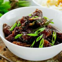 Mongolian Beef · Tender sliced beef stir fried with scallions, onions and a savory ginger, garlic, chili, soy...
