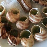 Escargot Aka Snails | Dozen · A dozen snails in a herb garlic butter with baguette