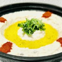 Baba Ghanouj (Comes With A Pita Bread) · Mashed cooked eggplant, garlic, lemon juice, tahini sauce, and special spices. Garnished wit...