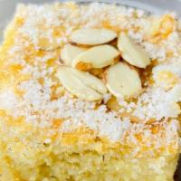 Namoura · Mediterranean cake made with semolina and aromatic syrup, topped with almond and coconut.