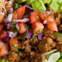 Taco Salad · House-made tortilla bowl filled with lettuce, pico de gallo, beef, cheese, chipotle sauce, a...