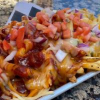Chile Cheese Fries · Housemade NM green or red chile sauce, cheddar cheese, you know the drill. Topped with diced...