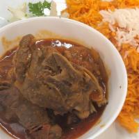 Seasoned Goat Meat Platter · Served with rice and salad.