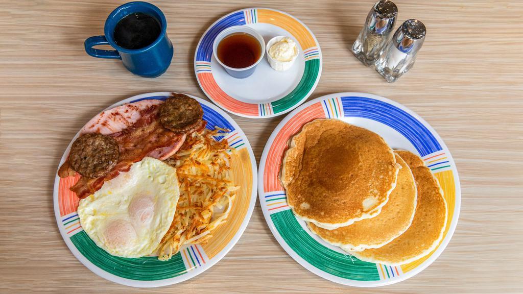 The Lumberjack Breakfast · Three eggs served with a thick slice of ham, two sausages, two strips of bacon, hash browns and choice of three large hotcakes or french toast.