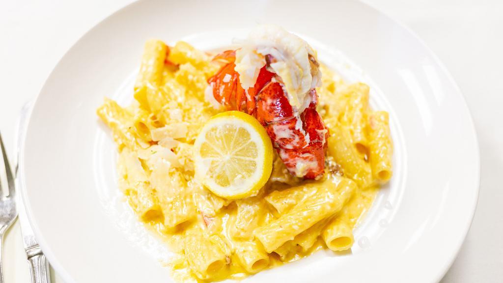 Lobster Mac & Cheese · Three cheese blend, hickory bacon, roasted red pepper topped w/ Maine Lobster tail