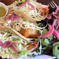 Fish Tacos (3) · Three Baja-style beer battered rockfish tacos on corn tortillas with house-made tartar, gree...