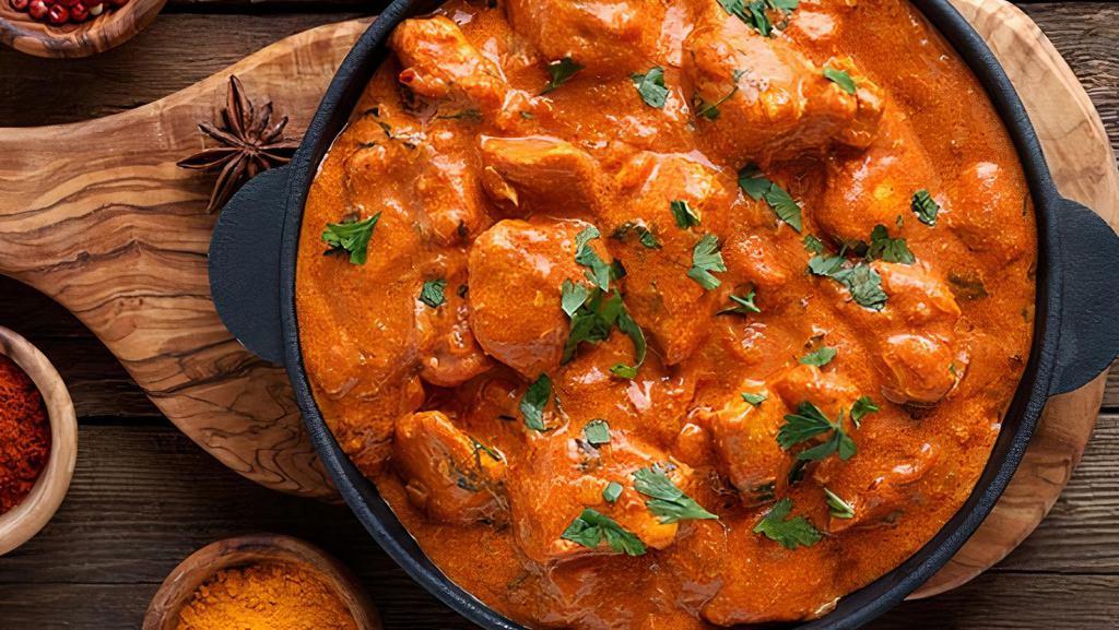 Butter Chicken · Yogurt based marinated chicken cubes cooked in rich onion, tomato & cashew sauce topped with a knob of butter.