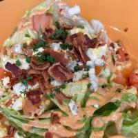 Wedge Salad · ICEBERG TOPPED WITH BACON, TOMATOES, BOILED EGG, BLUE CHEESE, CHIVES, AND BLUE CHEESE DRESSING